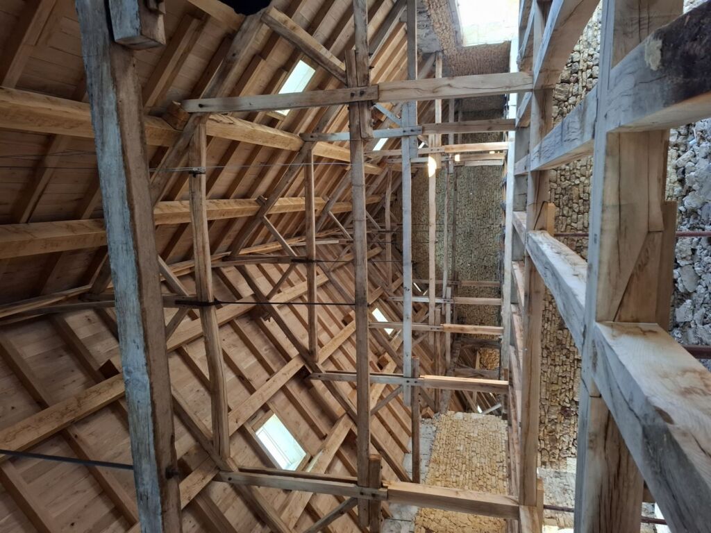 Monumentale eiken kapconstructie van de oude hoeve van Domaine 1791 tijdens de restauratie